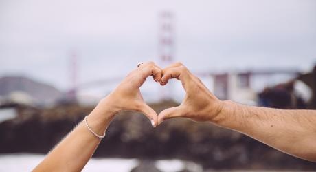 people making a heart shape with their hands