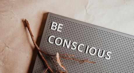 "be conscious" written on a bulletin board